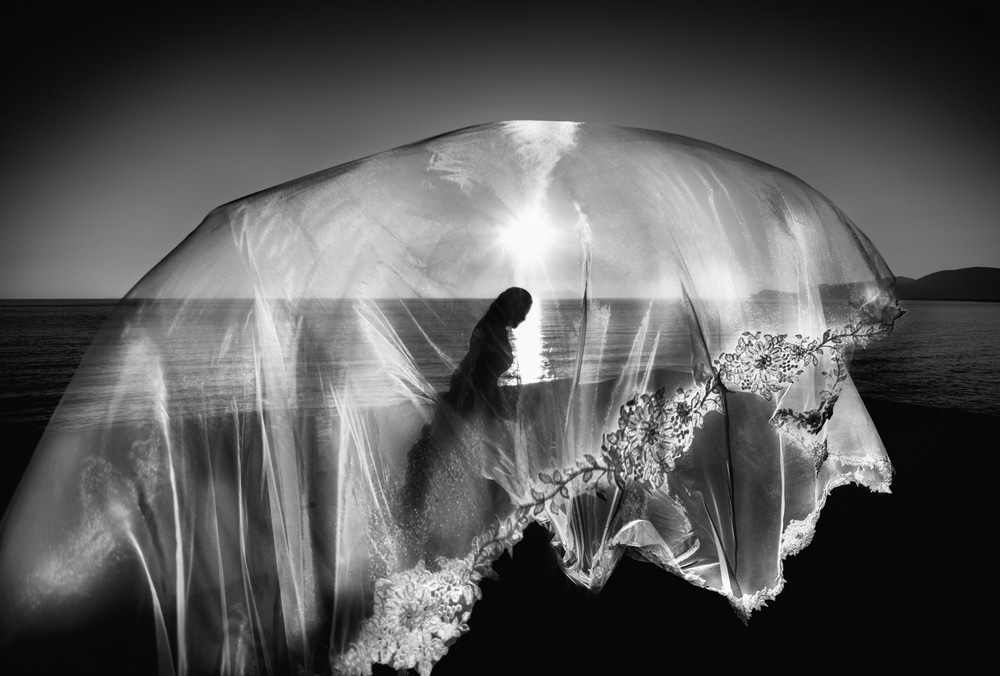 a bridal veil flying on the beach