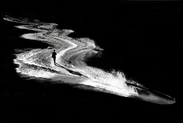 man walking on waves, black and white photo